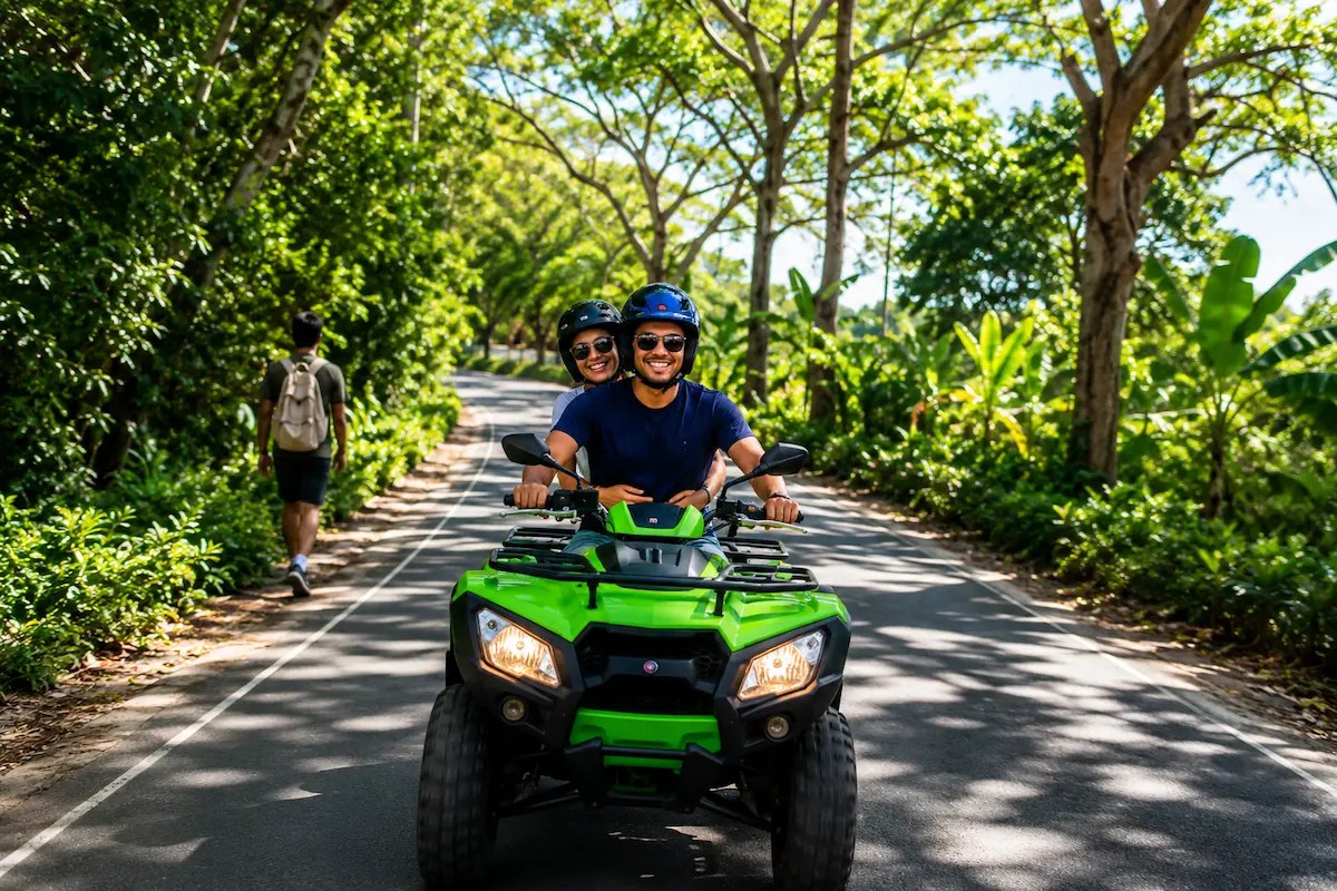 Couple on ATV adventure tour along tropical road in Nosy Be Madagascar