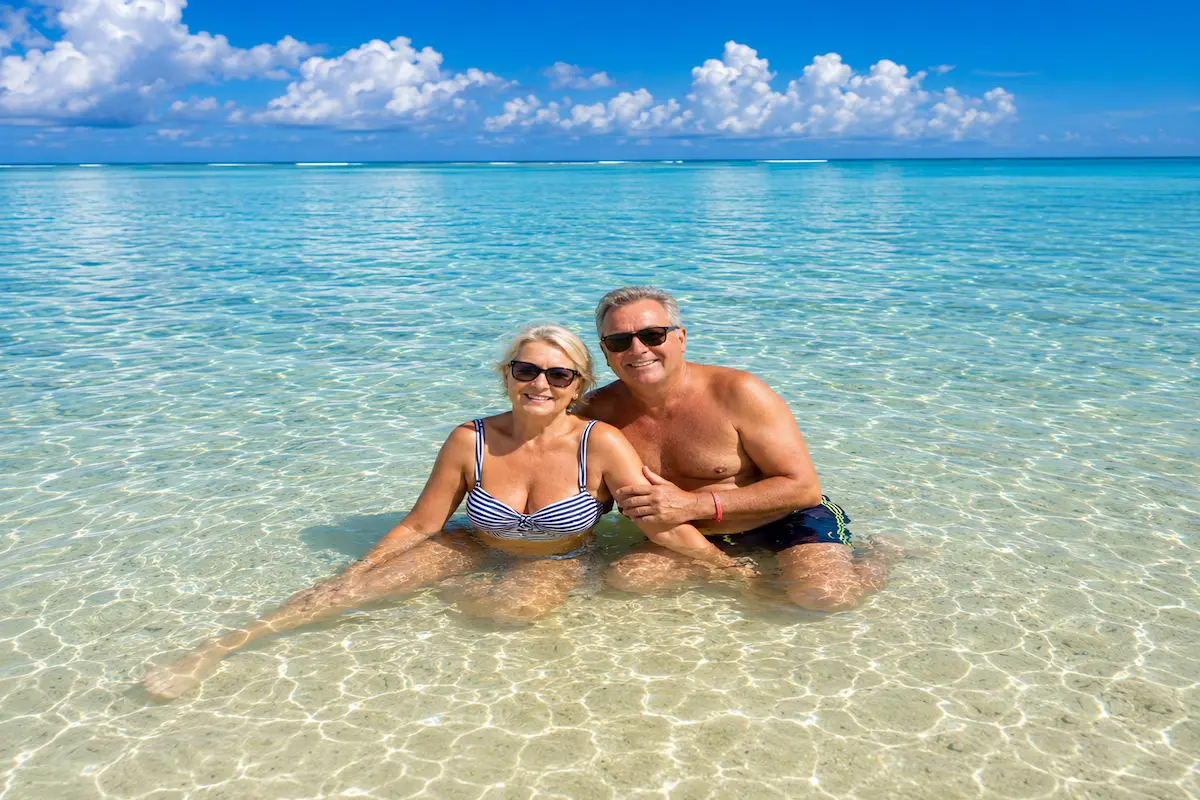 Couple relaxing Nosy Iranja crystal clear water