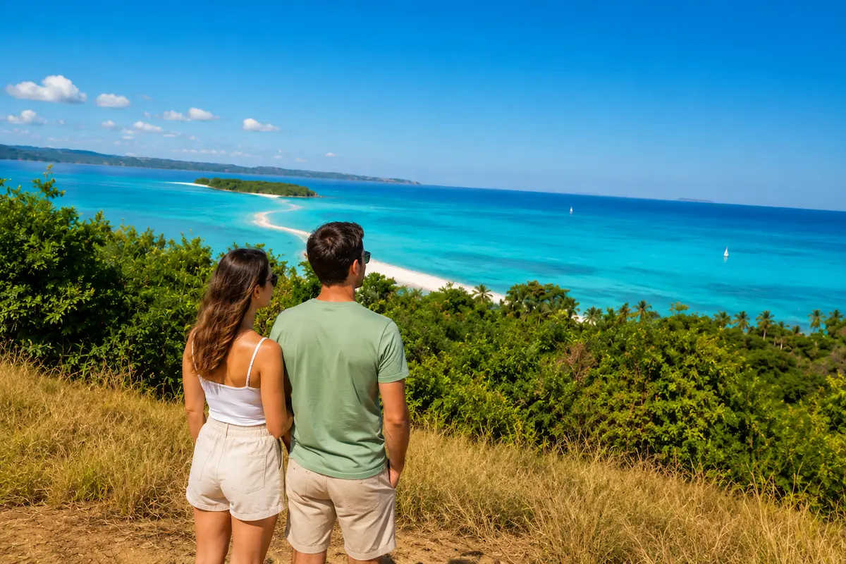 Couple overlooking the sandbank from Nosy Iranja viewpoint in Madagascar