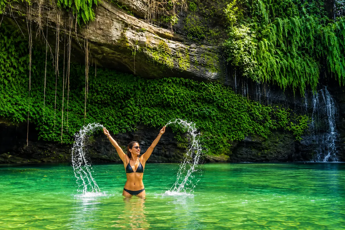 Swimming in rainforest waterfall in Madagascar