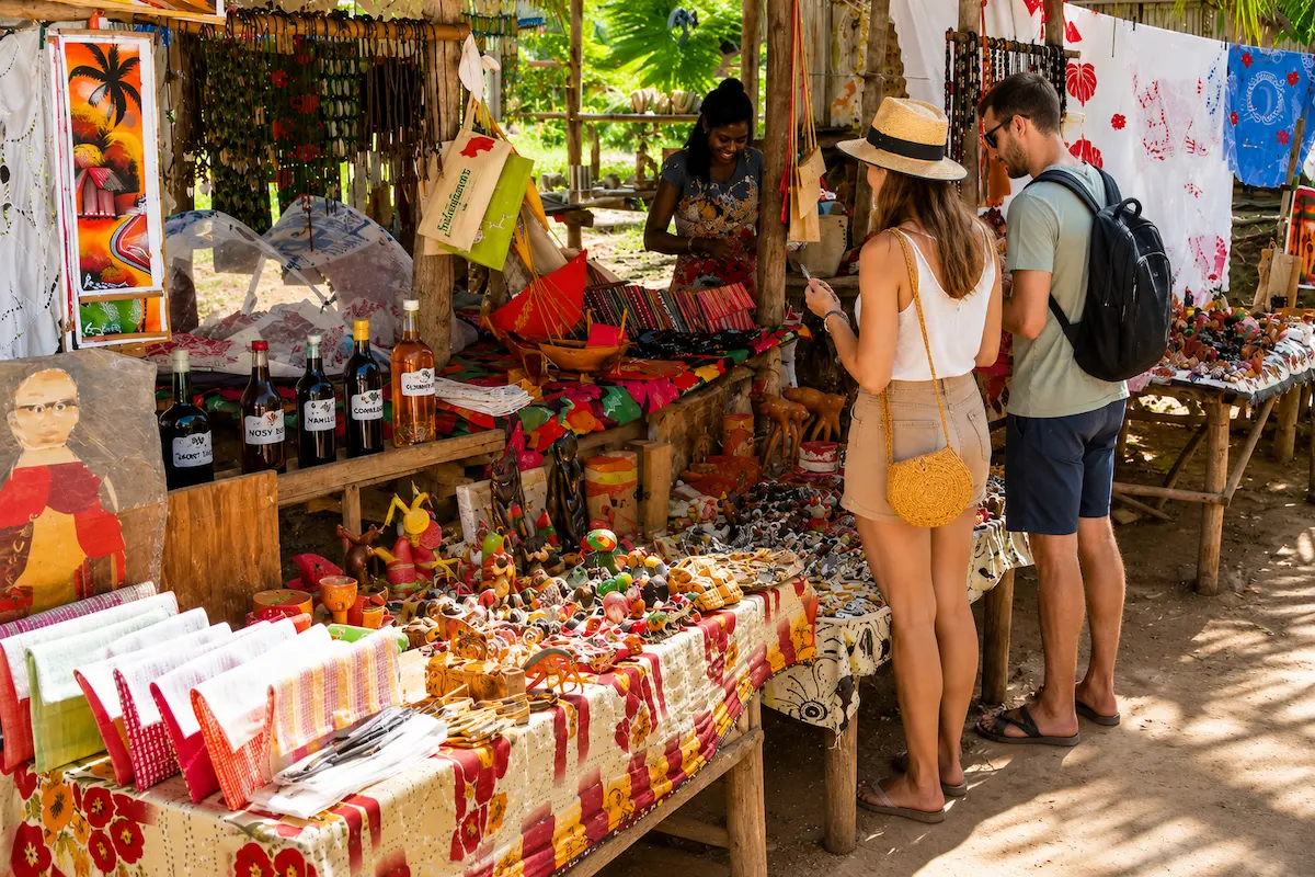 Tourists shopping for handmade crafts in Nosy Komba village, Madagascar