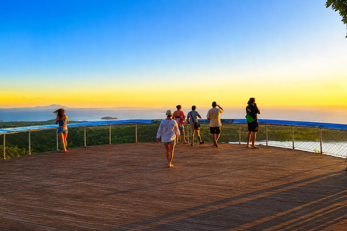 Tourists watching the sunset at Mont Passot, Nosy Be, Madagascar
