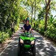 Couple on ATV adventure tour along tropical road in Nosy Be Madagascar