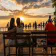 Couple watching sunset at Mont Passot in Nosy Be Madagascar
