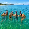 Tourists snorkeling in the crystal clear waters of Nosy Sakatia