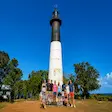 Tourists taking photo at Nosy Iranja lighthouse in Madagascar
