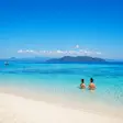 Couple swimming at Nosy Tanikely beach in Nosy Be Madagascar