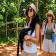 Tourist holding lemurs in Nosy Komba, Madagascar