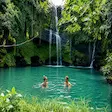 Tourist swimming at the Sacred Waterfall in Nosy Be, Madagascar