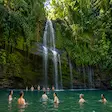 Tourists enjoying a waterfall swimming tour during Nosy Be Madagascar excursion